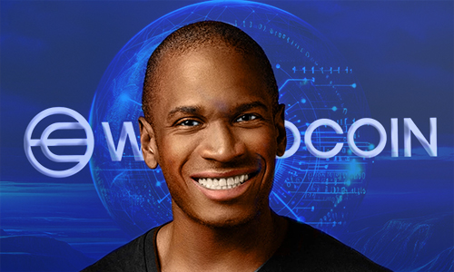 Portrait of a smiling Black man with a blue digital globe and the word WorldCoin in the background.