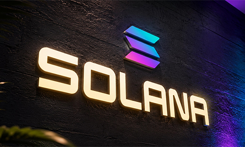 Solana logo on a dark textured wall, illuminated letters with a blue-purple symbol above.
